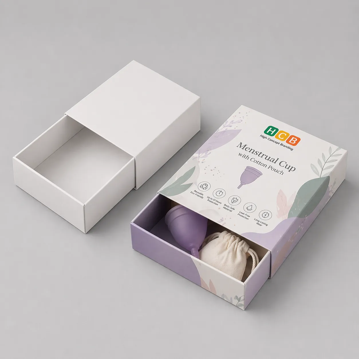 Two square cardboard boxes, one plain white and one with elegant pink floral feminine care branding. class=